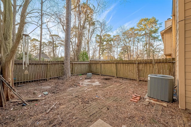 view of yard with a fenced backyard and central AC