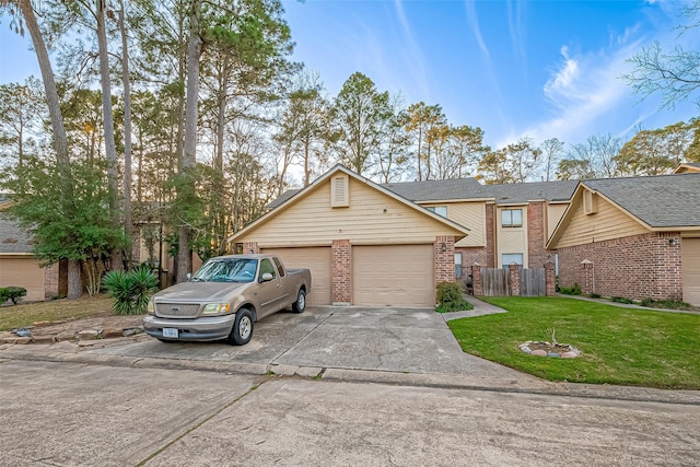 view of front of home featuring a front lawn, a garage, fence, and brick siding