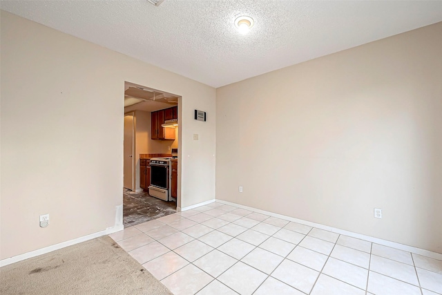 unfurnished room featuring baseboards and a textured ceiling