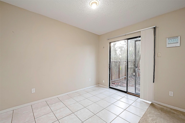 unfurnished room featuring baseboards and a textured ceiling