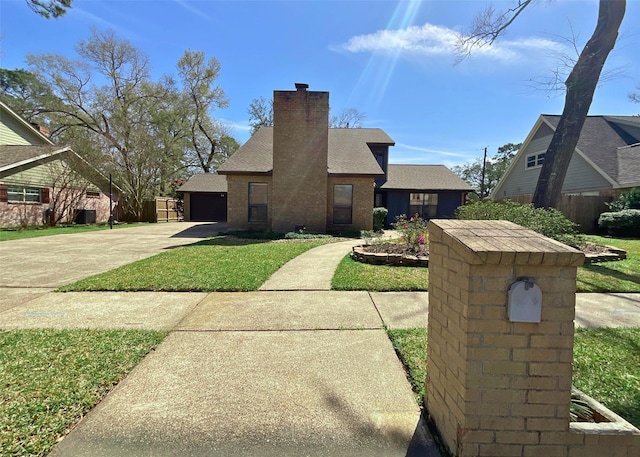 view of front of home with a garage, brick siding, a chimney, and fence