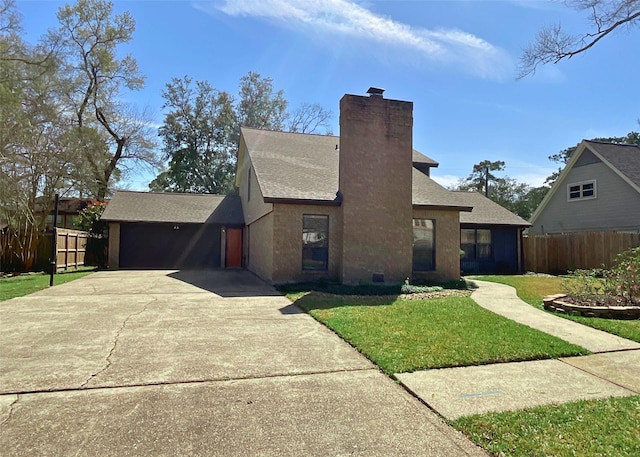 view of front of house with a front lawn, concrete driveway, a chimney, and fence