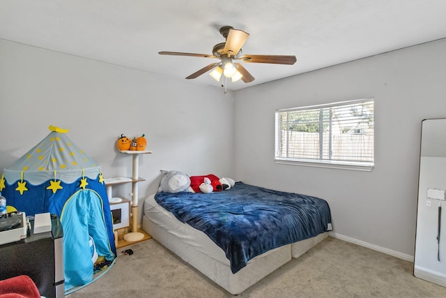 carpeted bedroom featuring baseboards and a ceiling fan