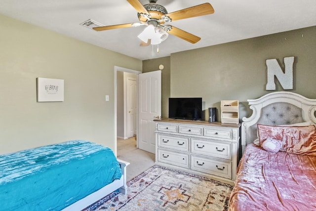 bedroom with light colored carpet, visible vents, and ceiling fan