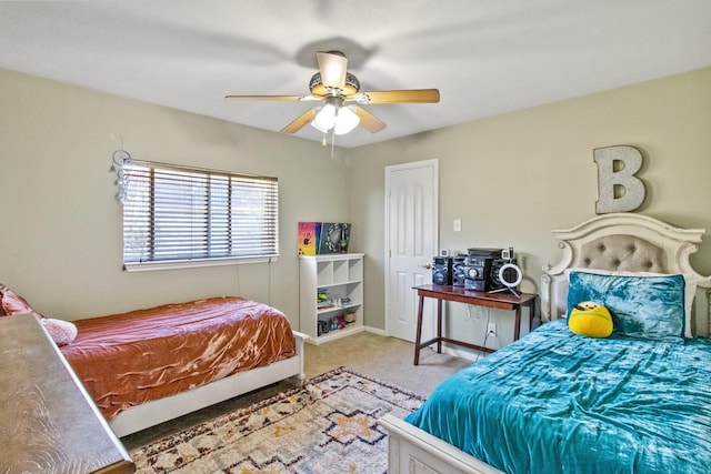 carpeted bedroom with baseboards and a ceiling fan