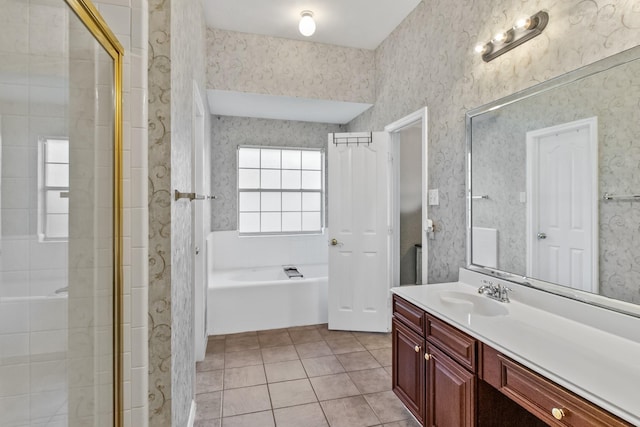 bathroom with tile patterned floors, wallpapered walls, vanity, and a bath