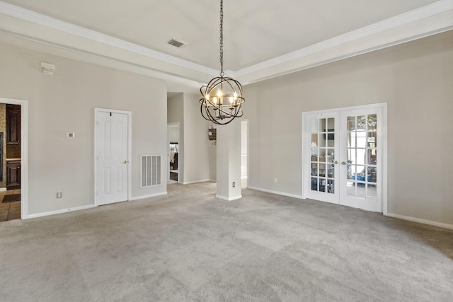 unfurnished room featuring a tray ceiling, visible vents, a chandelier, and french doors