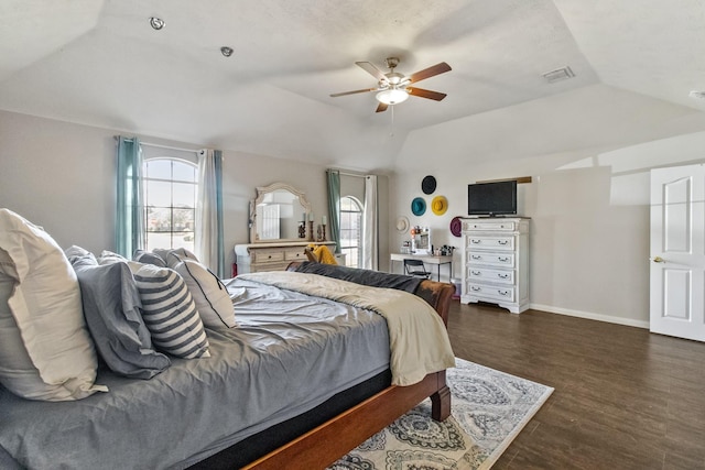 bedroom with visible vents, baseboards, dark wood finished floors, ceiling fan, and vaulted ceiling