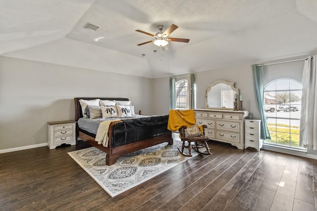 bedroom featuring a ceiling fan, baseboards, visible vents, dark wood finished floors, and lofted ceiling