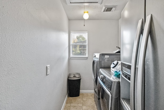 laundry area with visible vents, baseboards, attic access, tile patterned floors, and washing machine and dryer