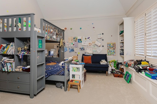 carpeted bedroom with crown molding and vaulted ceiling