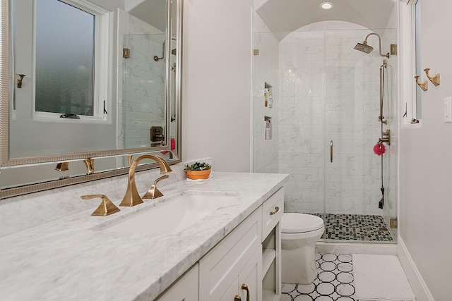 full bathroom featuring vanity, toilet, baseboards, and a stall shower