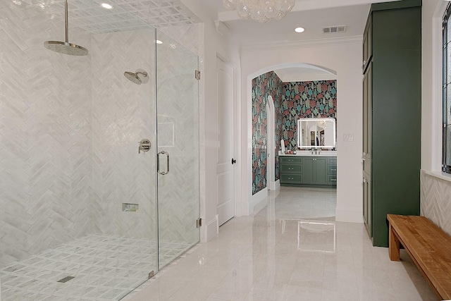 full bathroom with vanity, baseboards, visible vents, a stall shower, and ornamental molding