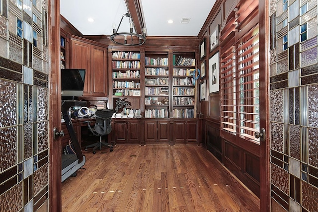 unfurnished office featuring recessed lighting, visible vents, wood finished floors, and built in study area