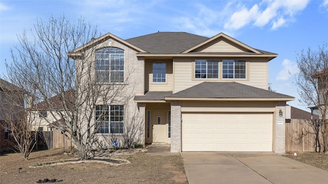 traditional-style home featuring a garage, fence, brick siding, and driveway