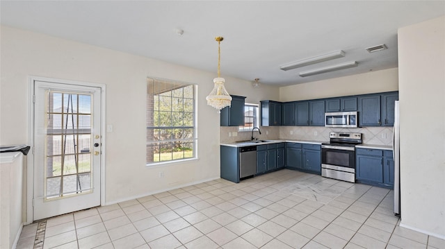 kitchen featuring visible vents, light countertops, appliances with stainless steel finishes, blue cabinets, and tasteful backsplash