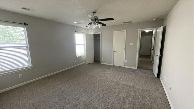 unfurnished bedroom with visible vents, multiple windows, and baseboards