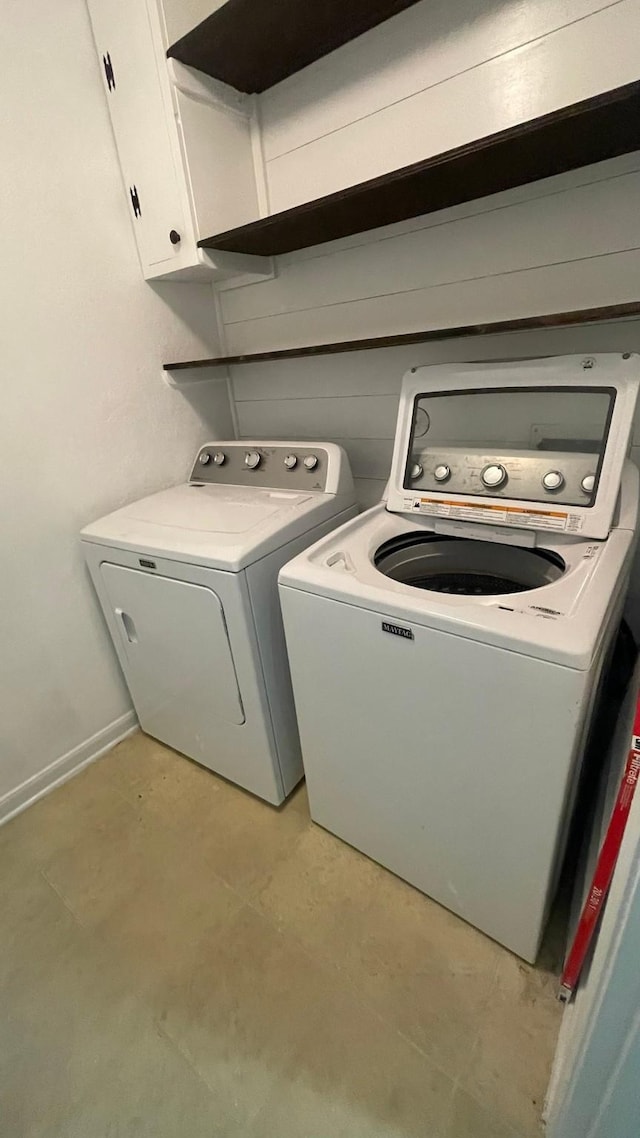 washroom with washing machine and dryer and cabinet space