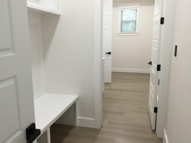 mudroom with baseboards and light wood-style flooring