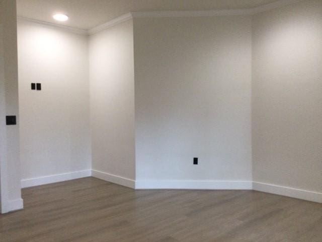 unfurnished room with crown molding, recessed lighting, wood finished floors, and baseboards