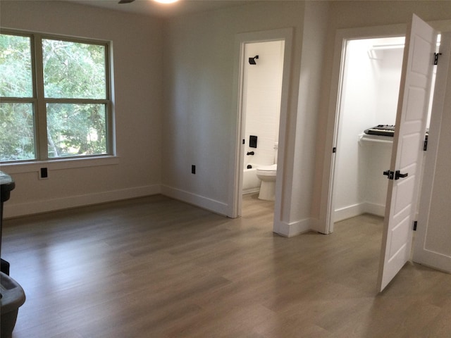 interior space featuring baseboards and light wood-type flooring