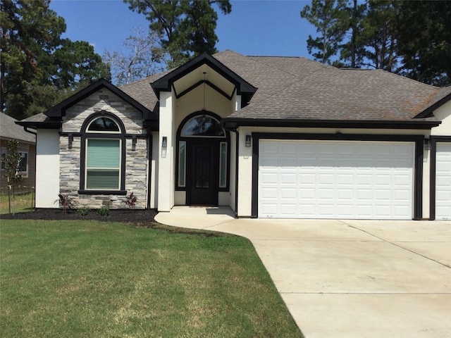 view of front of house with a front yard, roof with shingles, driveway, stone siding, and an attached garage