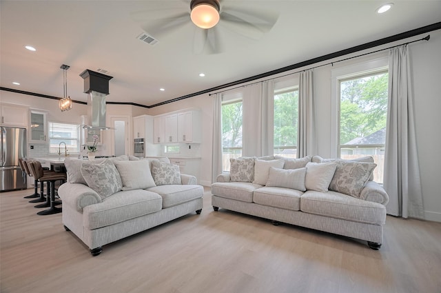 11706 Walden Rd, Montgomery, TX 77356 - living area featuring light wood-style floors, ceiling fan, ornamental molding, and visible vents