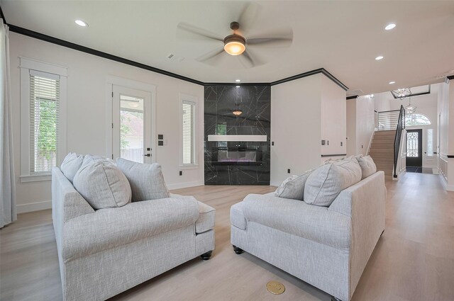 11706 Walden Rd, Montgomery, TX 77356 - living area with baseboards, a ceiling fan, light wood finished floors, and stairway