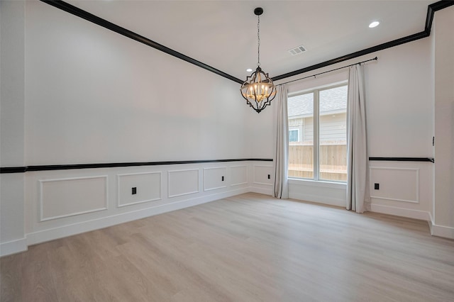 11706 Walden Rd, Montgomery, TX 77356 - unfurnished room featuring visible vents, an inviting chandelier, light wood finished floors, and a decorative wall