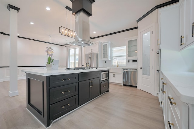 11706 Walden Rd, Montgomery, TX 77356 - kitchen featuring light wood-style floors, glass insert cabinets, appliances with stainless steel finishes, dark cabinets, and white cabinetry