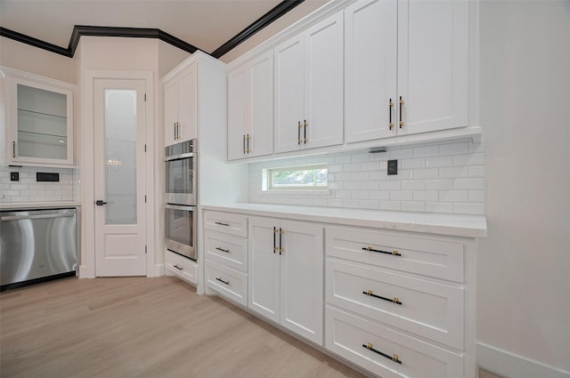 11706 Walden Rd, Montgomery, TX 77356 - kitchen featuring glass insert cabinets, white cabinetry, light wood-style flooring, appliances with stainless steel finishes, and backsplash