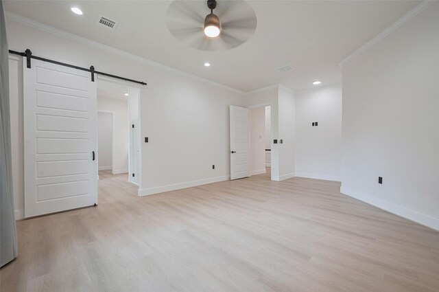 11706 Walden Rd, Montgomery, TX 77356 - unfurnished bedroom featuring crown molding, recessed lighting, a barn door, and light wood-style flooring