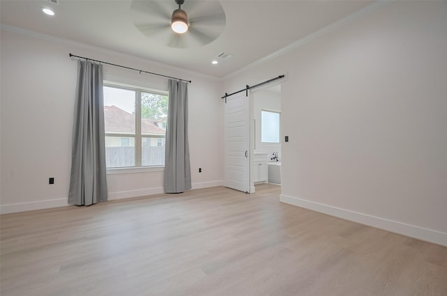 11706 Walden Rd, Montgomery, TX 77356 - empty room with crown molding, a ceiling fan, light wood finished floors, and a barn door