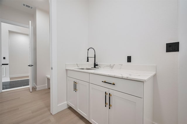 11706 Walden Rd, Montgomery, TX 77356 - bathroom featuring baseboards, visible vents, wood finished floors, and vanity