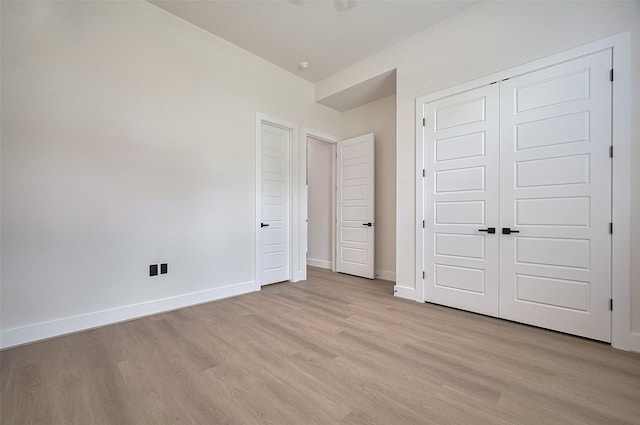 11706 Walden Rd, Montgomery, TX 77356 - unfurnished bedroom with baseboards, light wood finished floors, and a closet