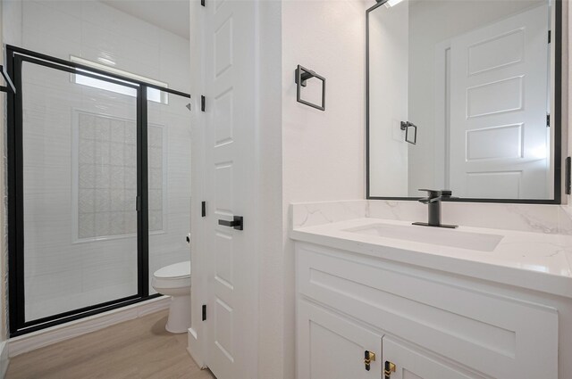 11706 Walden Rd, Montgomery, TX 77356 - full bath featuring vanity, a shower stall, toilet, and wood finished floors