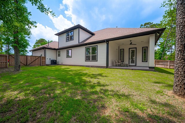 11706 Walden Rd, Montgomery, TX 77356 - back of property featuring roof with shingles, central AC, a fenced backyard, a patio area, and a yard