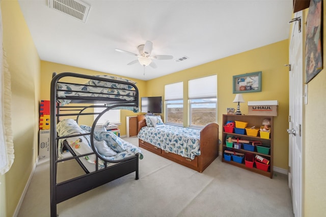 carpeted bedroom featuring visible vents, a ceiling fan, and baseboards