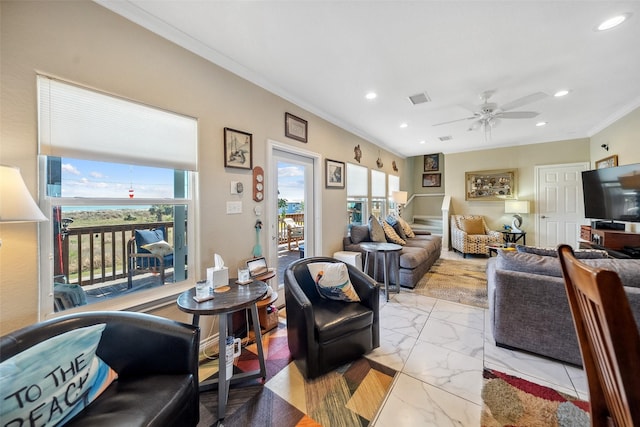 living room featuring a wealth of natural light, visible vents, marble finish floor, and crown molding