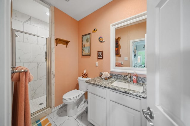 full bath featuring a marble finish shower, marble finish floor, toilet, and vanity