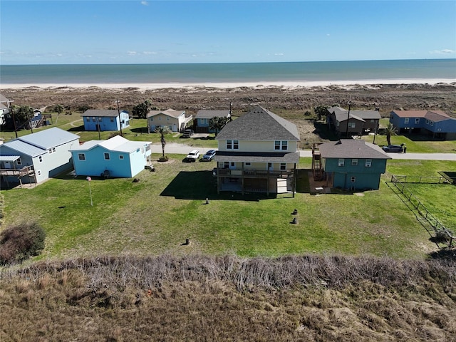 aerial view featuring a residential view, a water view, and a view of the beach