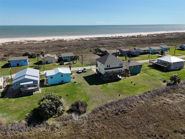 aerial view with a water view, a beach view, and a residential view