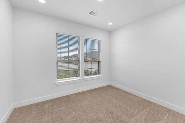 unfurnished room featuring recessed lighting, carpet, visible vents, and baseboards