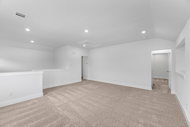 carpeted spare room featuring attic access, recessed lighting, visible vents, and lofted ceiling