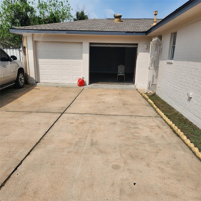 garage featuring concrete driveway