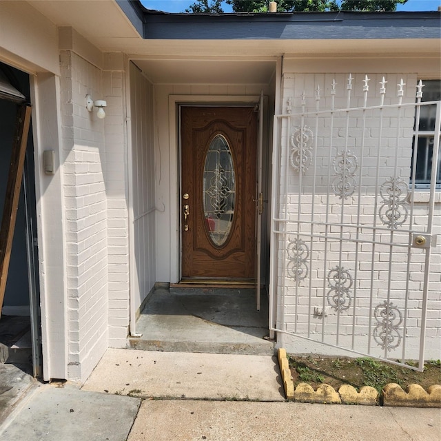 view of exterior entry with brick siding