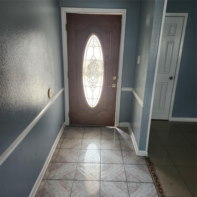 entrance foyer featuring baseboards and a textured wall