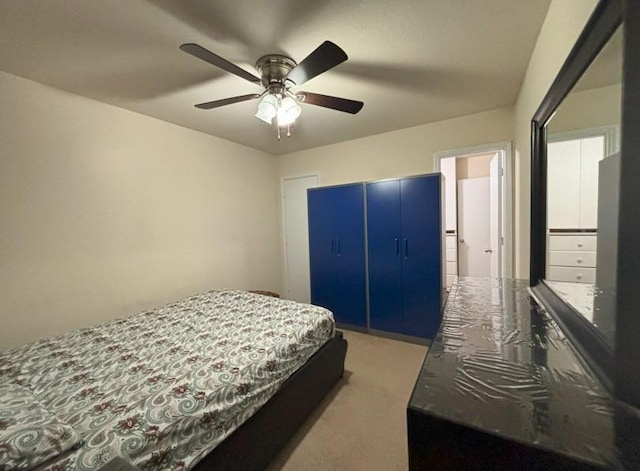 carpeted bedroom with a closet and ceiling fan