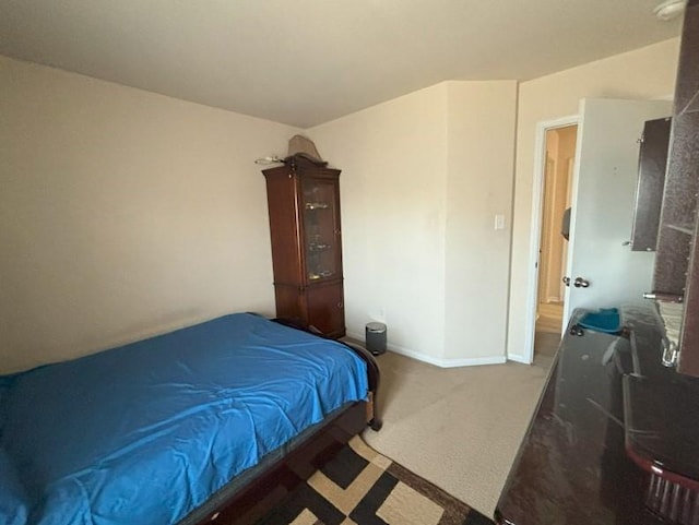 bedroom with carpet and baseboards