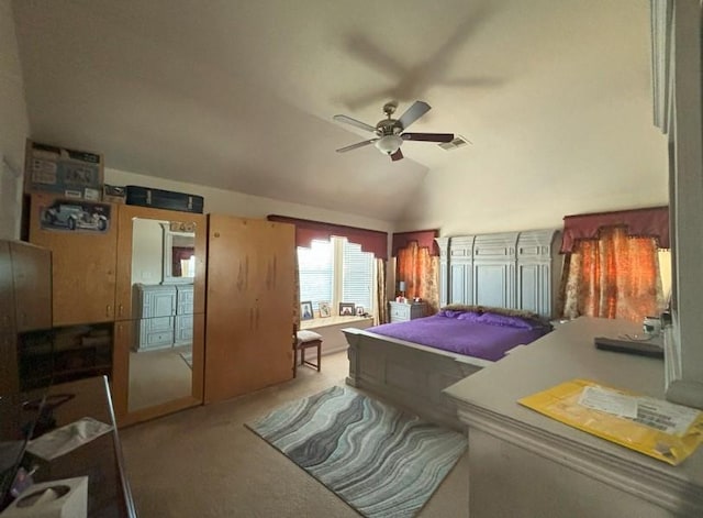 carpeted bedroom featuring lofted ceiling, visible vents, and ceiling fan